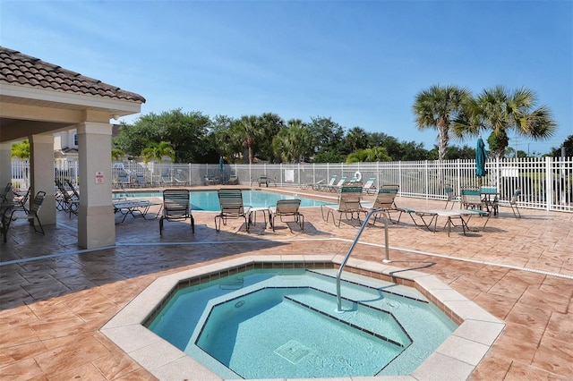 view of swimming pool with a patio and a community hot tub