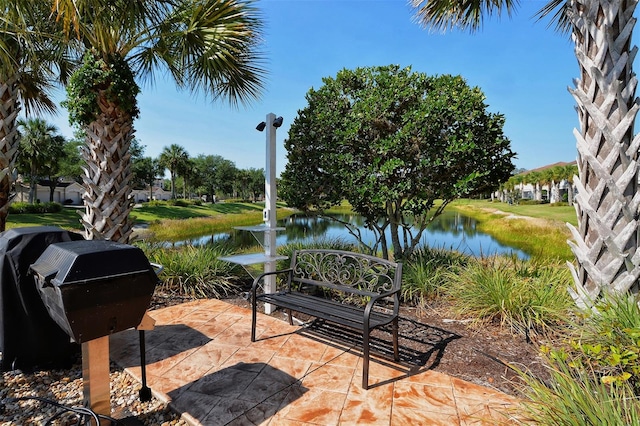 view of property's community with a water view and a patio