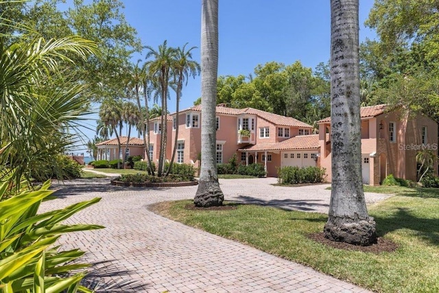 4511 Bay Shore Rd, Sarasota, FL 34234 - view of front of house featuring curved driveway, a tiled roof, and stucco siding