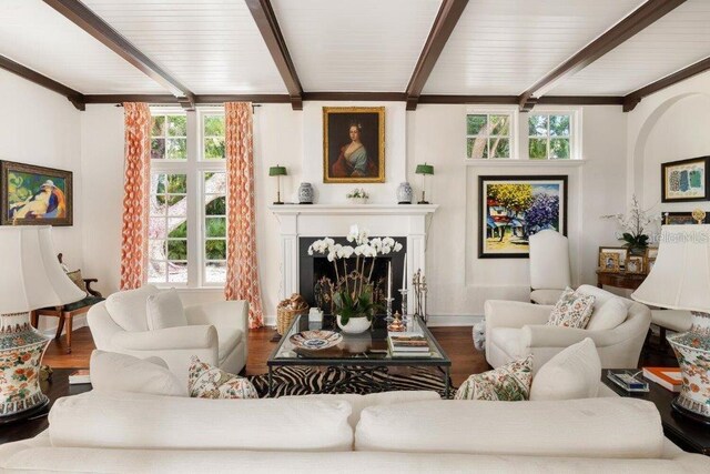4511 Bay Shore Rd, Sarasota, FL 34234 - living area featuring beamed ceiling, wood finished floors, a fireplace, and baseboards