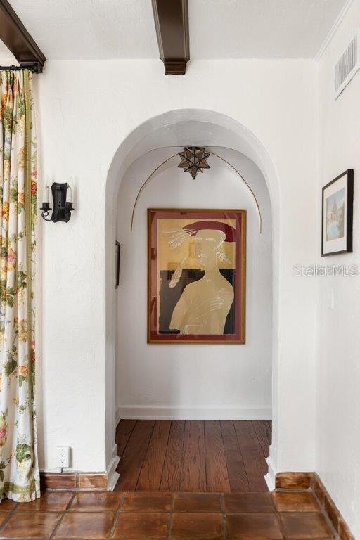 4511 Bay Shore Rd, Sarasota, FL 34234 - corridor featuring arched walkways, baseboards, and wood finished floors