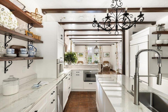 4511 Bay Shore Rd, Sarasota, FL 34234 - kitchen featuring open shelves, a sink, a chandelier, and white cabinets