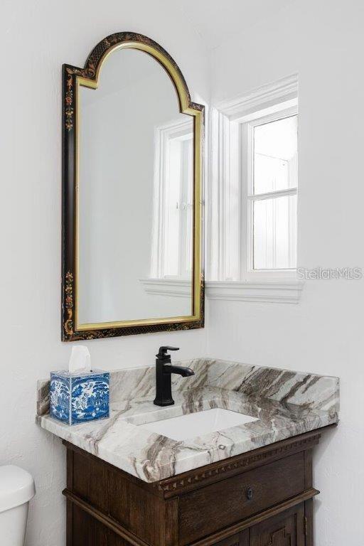 bathroom featuring vanity and toilet