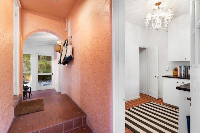 hallway with a chandelier