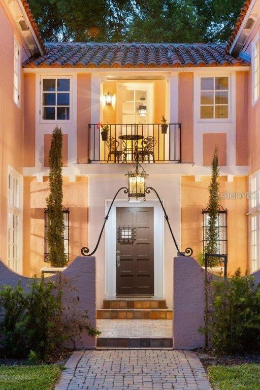4511 Bay Shore Rd, Sarasota, FL 34234 - doorway to property with a tile roof, stucco siding, and a balcony