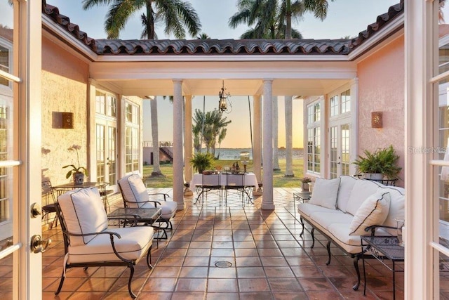 sunroom with ornate columns and french doors