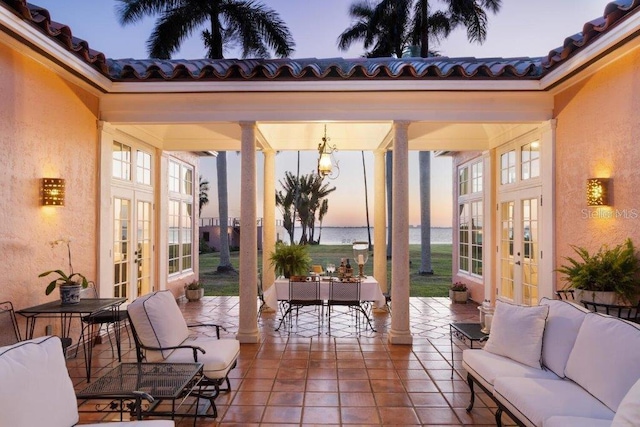 4511 Bay Shore Rd, Sarasota, FL 34234 - view of patio / terrace featuring french doors, outdoor lounge area, a water view, and outdoor dining area