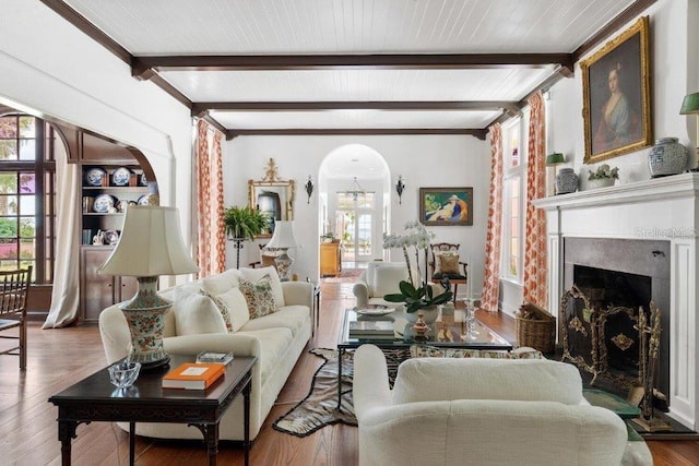 living room featuring wood-type flooring and beam ceiling