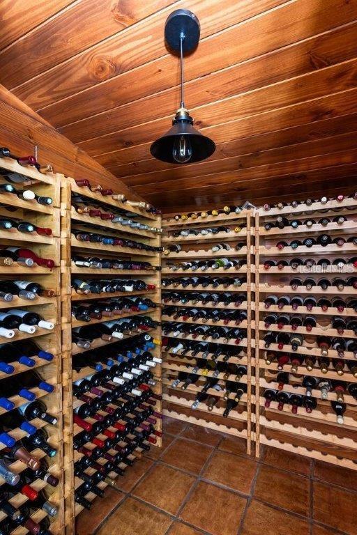 wine area featuring wood ceiling and dark tile patterned floors