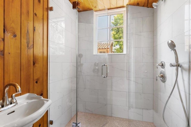 bathroom featuring sink and a shower with door