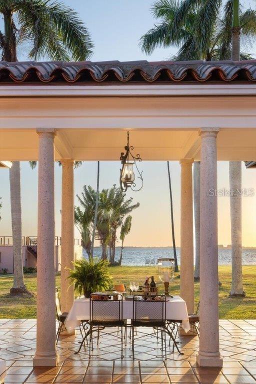 patio terrace at dusk with a gazebo and a water view