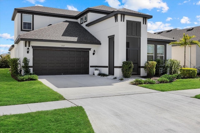 view of front of house featuring a garage and a front yard