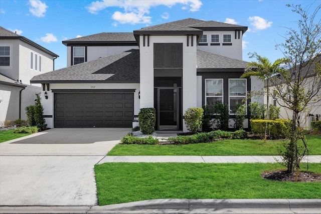 view of front facade with a front yard and a garage