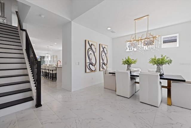 dining room with sink and an inviting chandelier