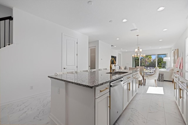 kitchen with a kitchen island with sink, sink, stone countertops, decorative light fixtures, and dishwasher