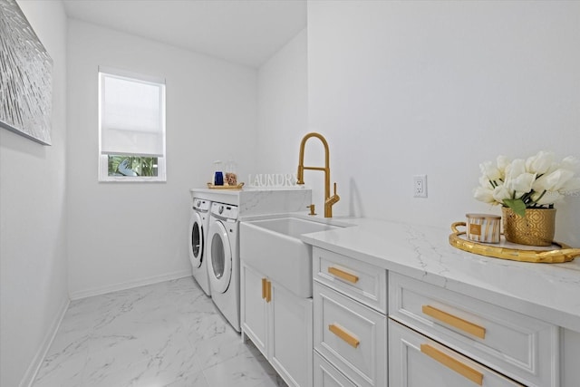 laundry area featuring sink, cabinets, and independent washer and dryer