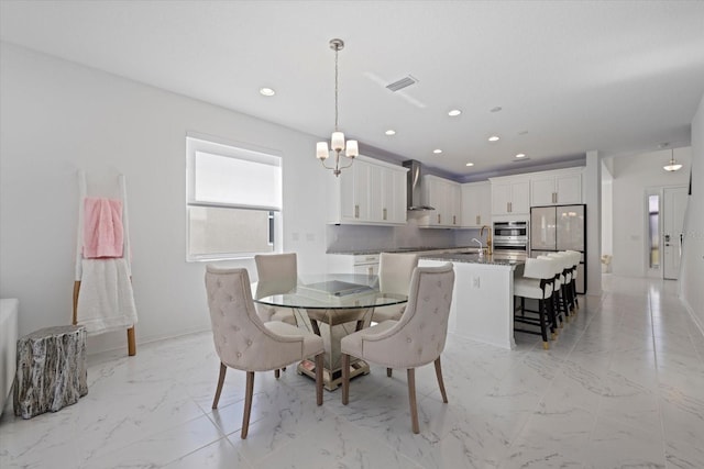 dining area with a chandelier and sink