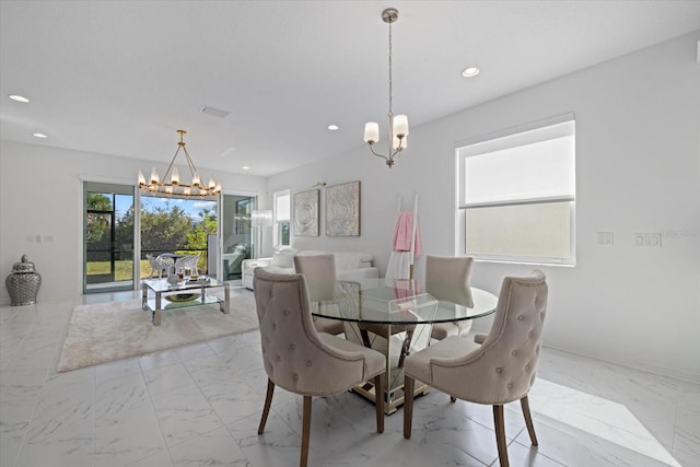 dining space with a chandelier