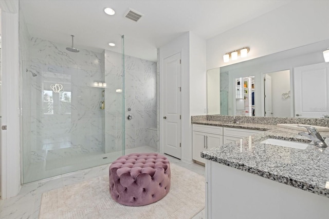 bathroom featuring vanity and tiled shower