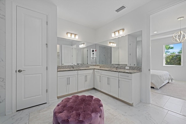 bathroom featuring a shower and vanity