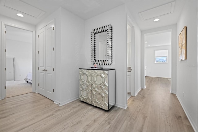 hallway with light hardwood / wood-style floors