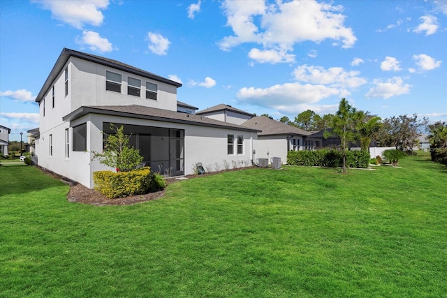 rear view of property with a yard and central air condition unit