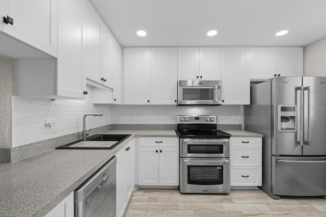 kitchen featuring sink, white cabinets, and appliances with stainless steel finishes