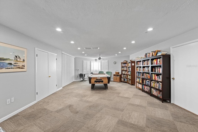 rec room featuring ceiling fan and a textured ceiling