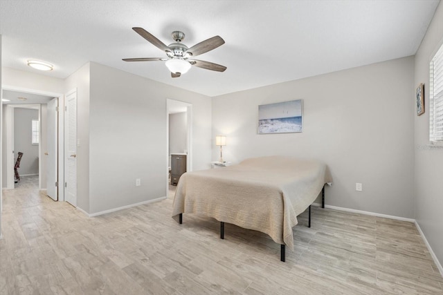 bedroom with ceiling fan, light hardwood / wood-style floors, and ensuite bath