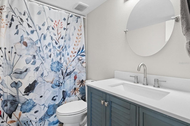 bathroom with vanity, a shower with shower curtain, and toilet