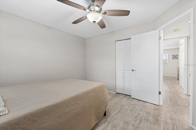 bedroom featuring a closet, ceiling fan, and light hardwood / wood-style flooring