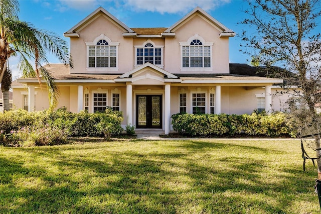 view of front facade featuring a front yard and french doors