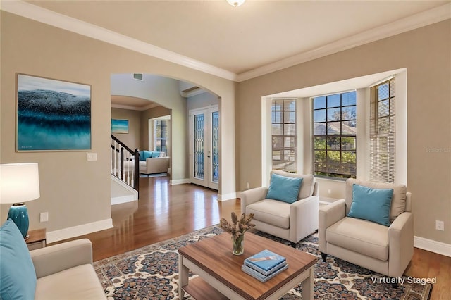 living room with crown molding, dark wood-type flooring, and french doors