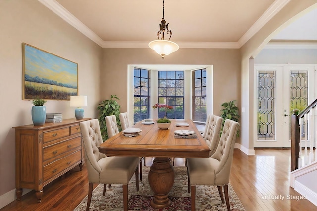 dining space with french doors, dark hardwood / wood-style flooring, and ornamental molding