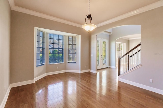 unfurnished room with hardwood / wood-style flooring and ornamental molding