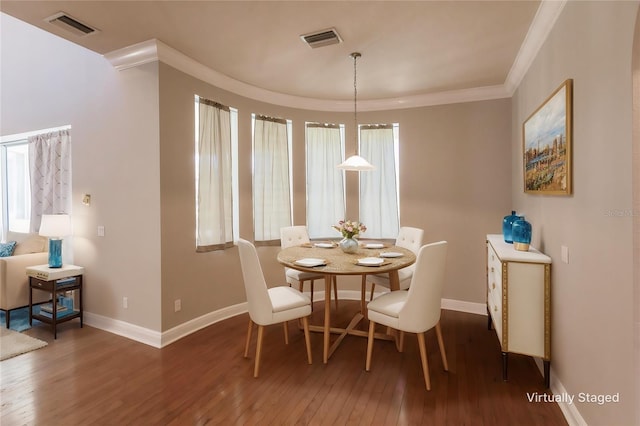 dining area featuring crown molding and dark hardwood / wood-style floors