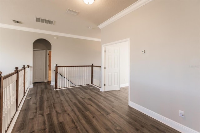 unfurnished room featuring dark hardwood / wood-style floors and ornamental molding