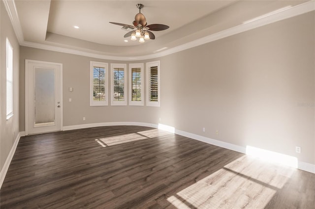 unfurnished room featuring dark hardwood / wood-style floors, ceiling fan, a raised ceiling, and ornamental molding