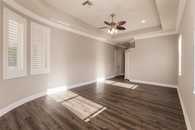 interior space featuring a raised ceiling, ceiling fan, dark hardwood / wood-style flooring, and crown molding