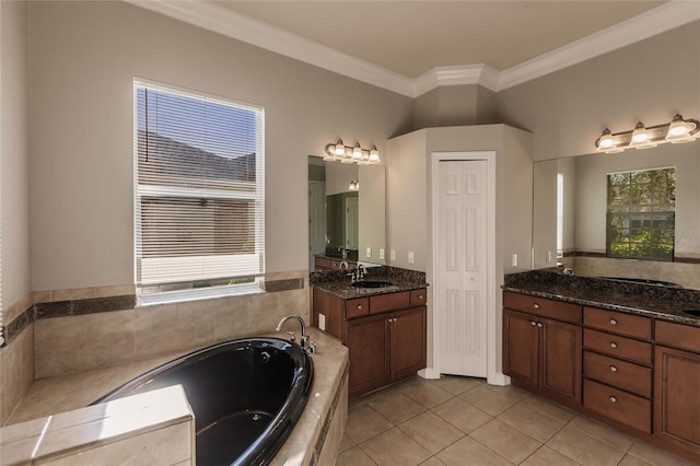 bathroom featuring tile patterned flooring, vanity, tiled bath, and crown molding