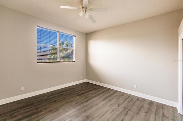 spare room featuring ceiling fan and dark wood-type flooring