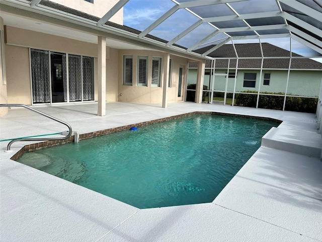 view of pool featuring a patio and glass enclosure