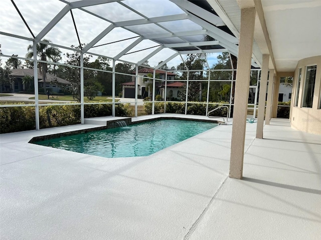 view of pool with pool water feature, a patio, and a lanai