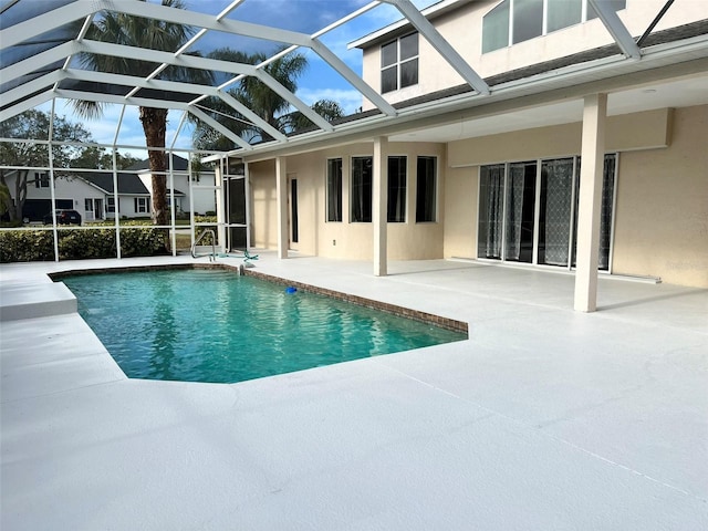 view of swimming pool featuring a lanai and a patio