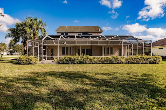 rear view of property with glass enclosure and a lawn