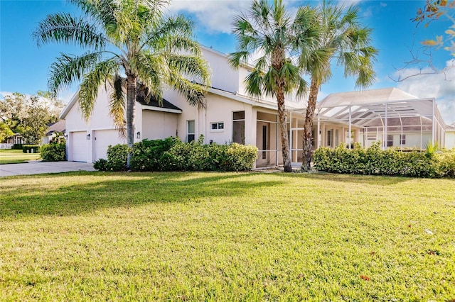 view of front facade with a front yard and glass enclosure