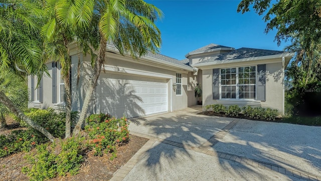7407 Sea Island Ln, Bradenton, FL 34201 - view of front of home featuring stucco siding, an attached garage, and driveway