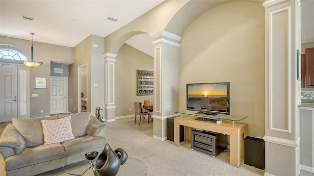 living room featuring light colored carpet and decorative columns