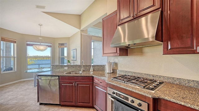 kitchen with appliances with stainless steel finishes, light stone counters, sink, light tile patterned floors, and hanging light fixtures