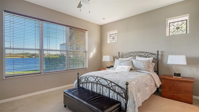 bedroom featuring light carpet and ceiling fan